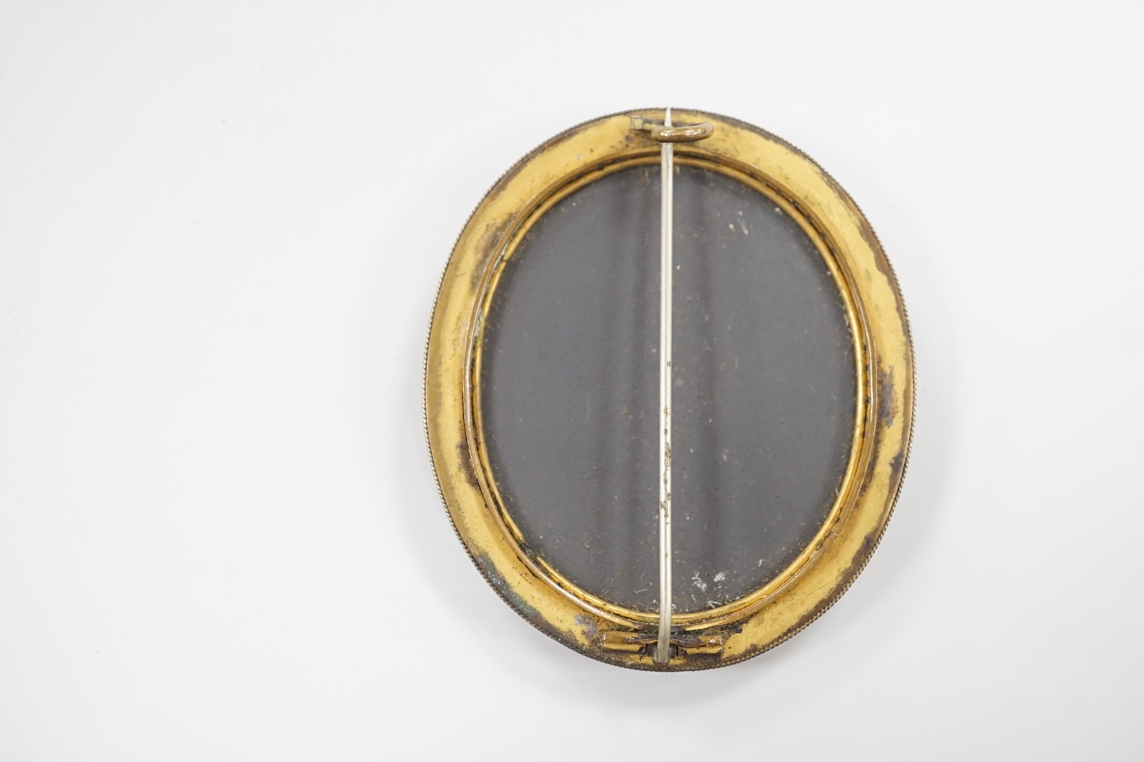 A gilt metal and Pietra Dura set oval brooch, 60mm.